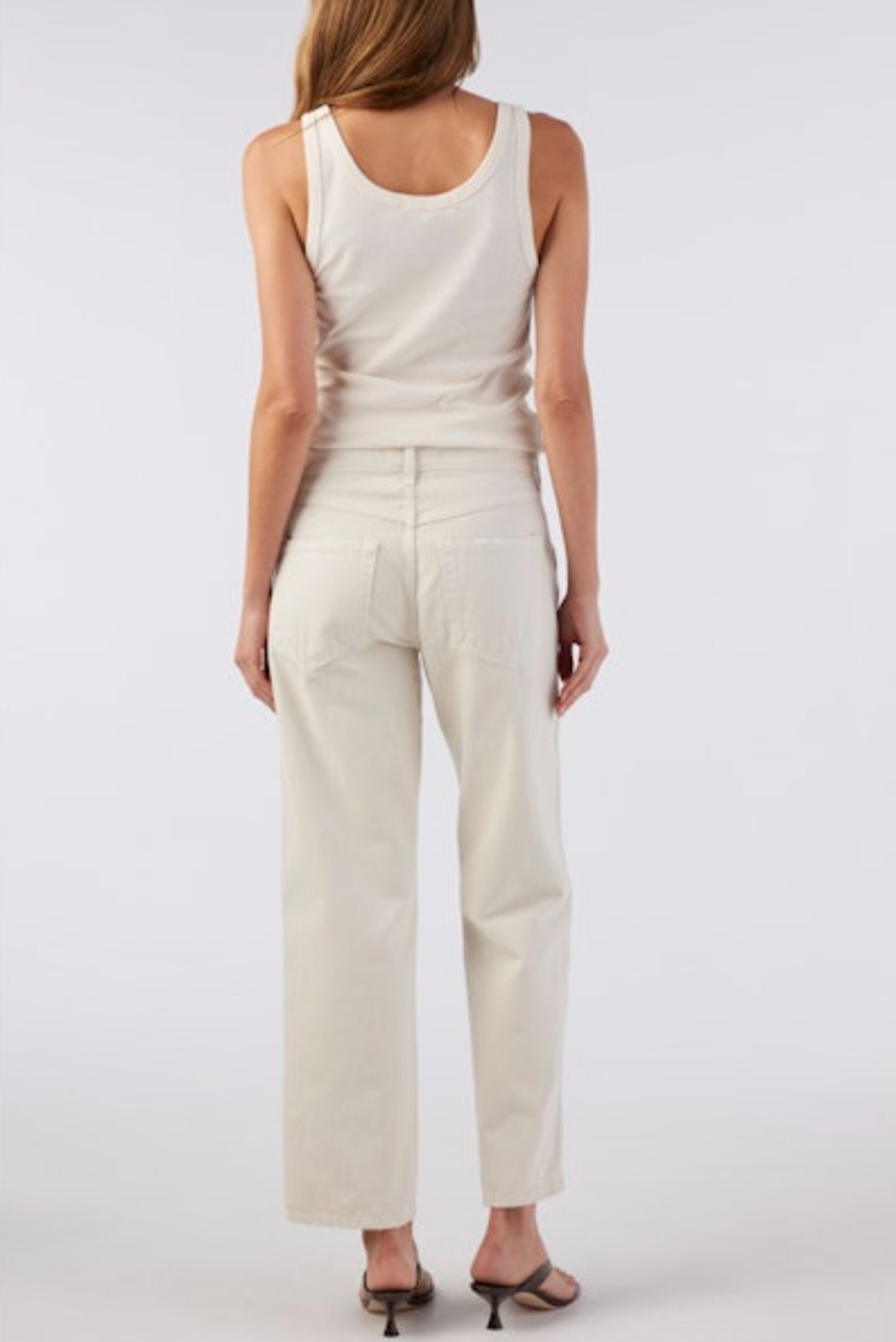 Image of model wearing AMO Denim Billie Straight Leg Jean in Sandstone (Natural White). Billie is a mid rise relaxed fit 100% Cotton Jean with a slight crop. Designed and made in Los Angeles.