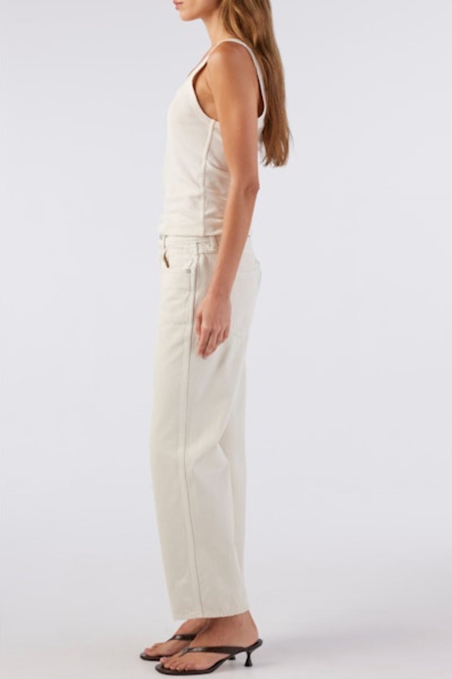 Image of model wearing AMO Denim Billie Straight Leg Jean in Sandstone (Natural White). Billie is a mid rise relaxed fit 100% Cotton Jean with a slight crop. Designed and made in Los Angeles.