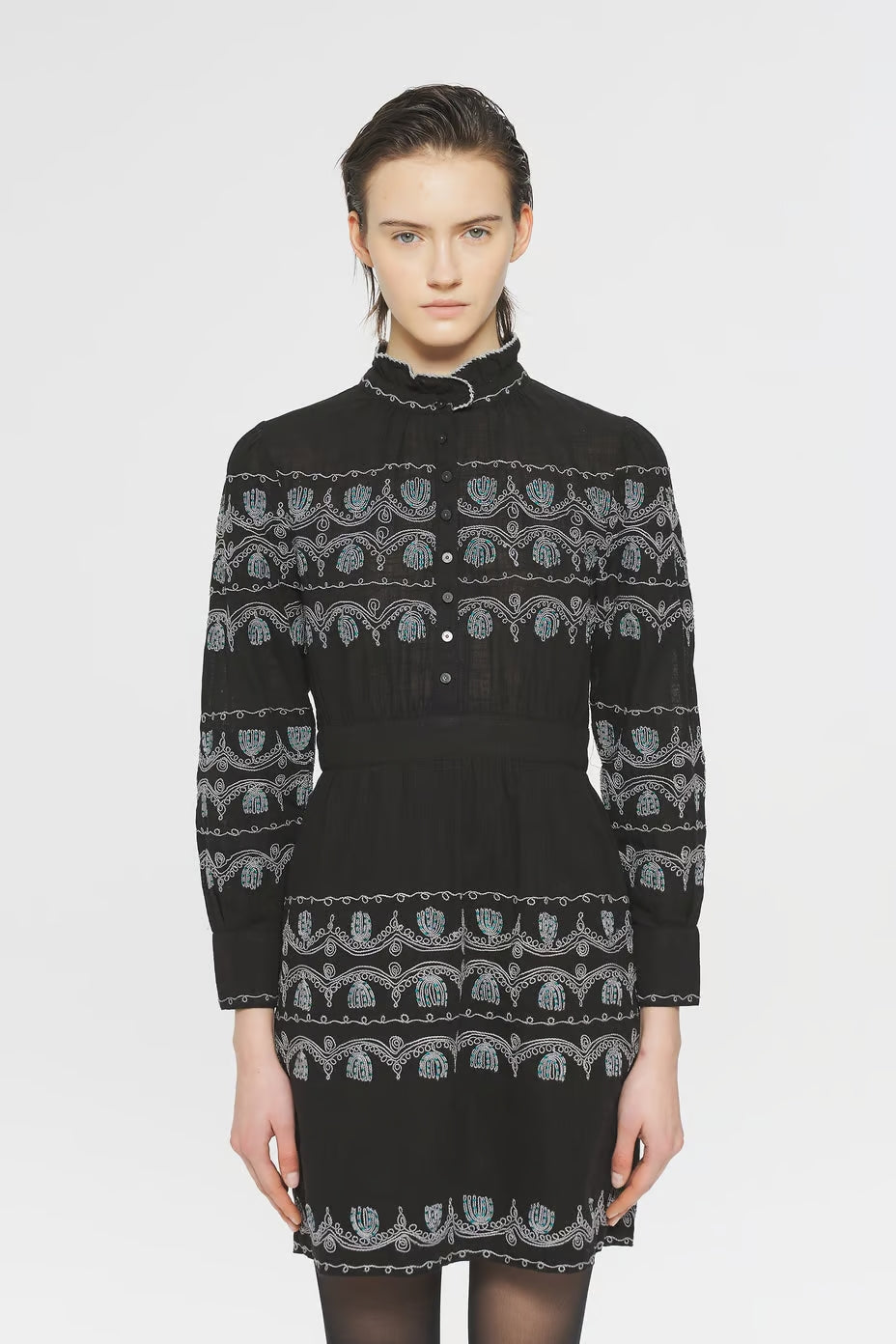 Image of model in Antik Batik Hungarian Style Nelly Mini Dress _ Fitted Women's Cotton Long Sleeve Dress with Handstitched Turquiose and White Embroidery _ Ethical French Bohemian Fashion _ Artisan Made Sustainable High Fashion