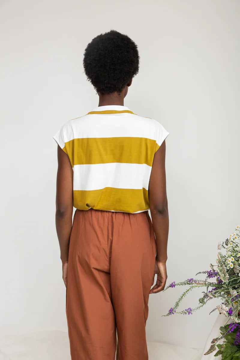 Image of model wearing Beaumont Organic Aukui T-Shirt in True White. Aukui is a cap sleeve tee with high crew neck and medium body length. Ethically made in Portugal from organic cotton.