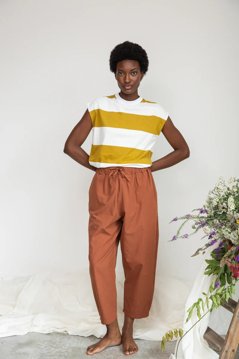Image of model wearing Beaumont Organic Aukui T-Shirt in True White. Aukui is a cap sleeve tee with high crew neck and medium body length. Ethically made in Portugal from organic cotton.