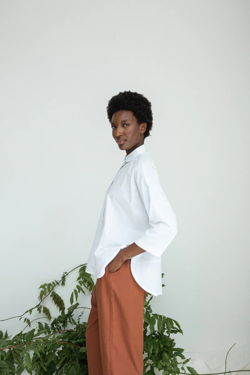 Image of model wearing BEAUMONT ORGANIC Lissie Button Down in White. Lissie is a 3/4 sleeve length boxy button down made from organic Cotton poplin and cotton jersey.