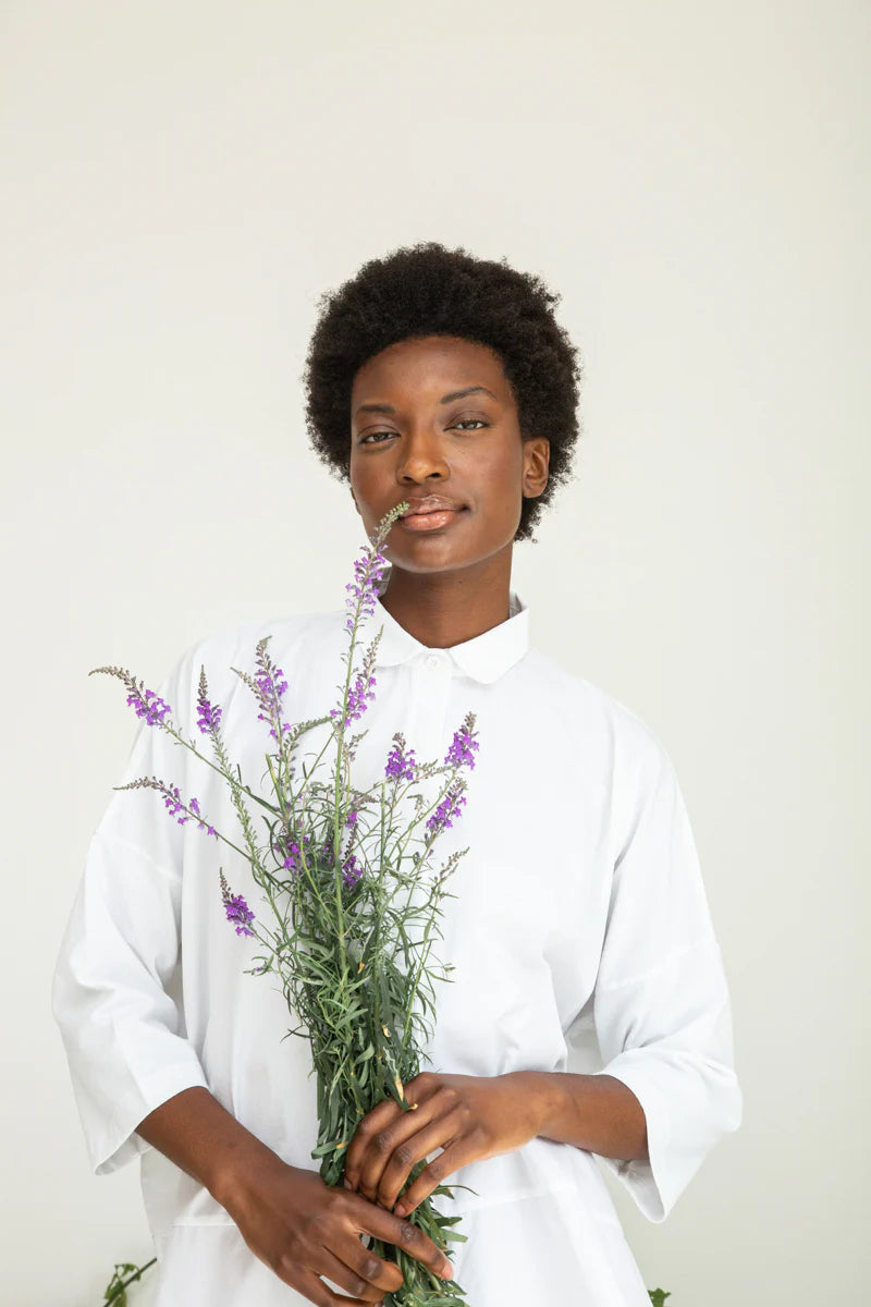 Image of model wearing BEAUMONT ORGANIC Lissie Button Down in White. Lissie is a 3/4 sleeve length boxy button down made from organic Cotton poplin and cotton jersey.