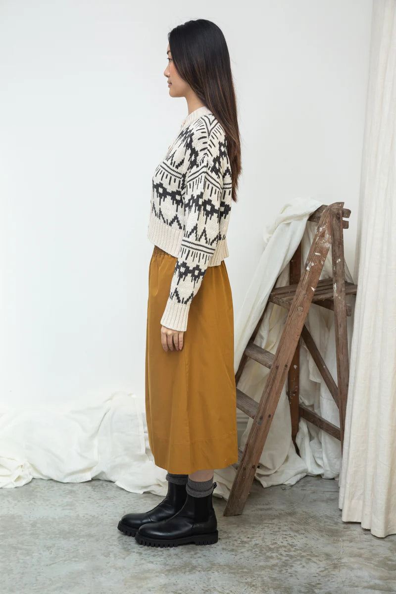 Image of model wearing BEAUMONT ORGANIC Sugi Sue Organic Cotton Knit Cardigan with Geometric Charcoal Fair Isle on Ivory yarn.