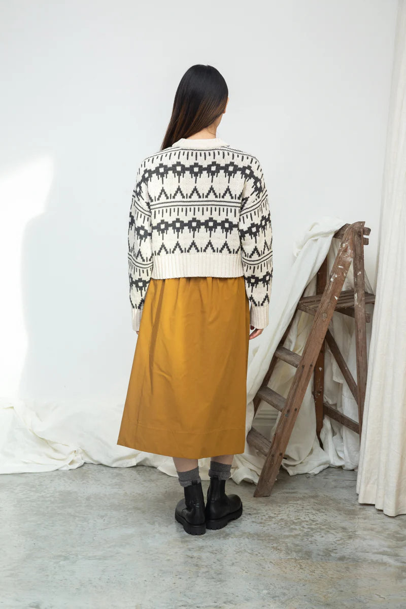Image of model wearing BEAUMONT ORGANIC Sugi Sue Organic Cotton Knit Cardigan with Geometric Charcoal Fair Isle on Ivory yarn.