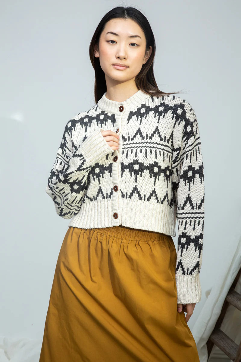 Image of model wearing BEAUMONT ORGANIC Sugi Sue Organic Cotton Knit Cardigan with Geometric Charcoal Fair Isle on Ivory yarn.