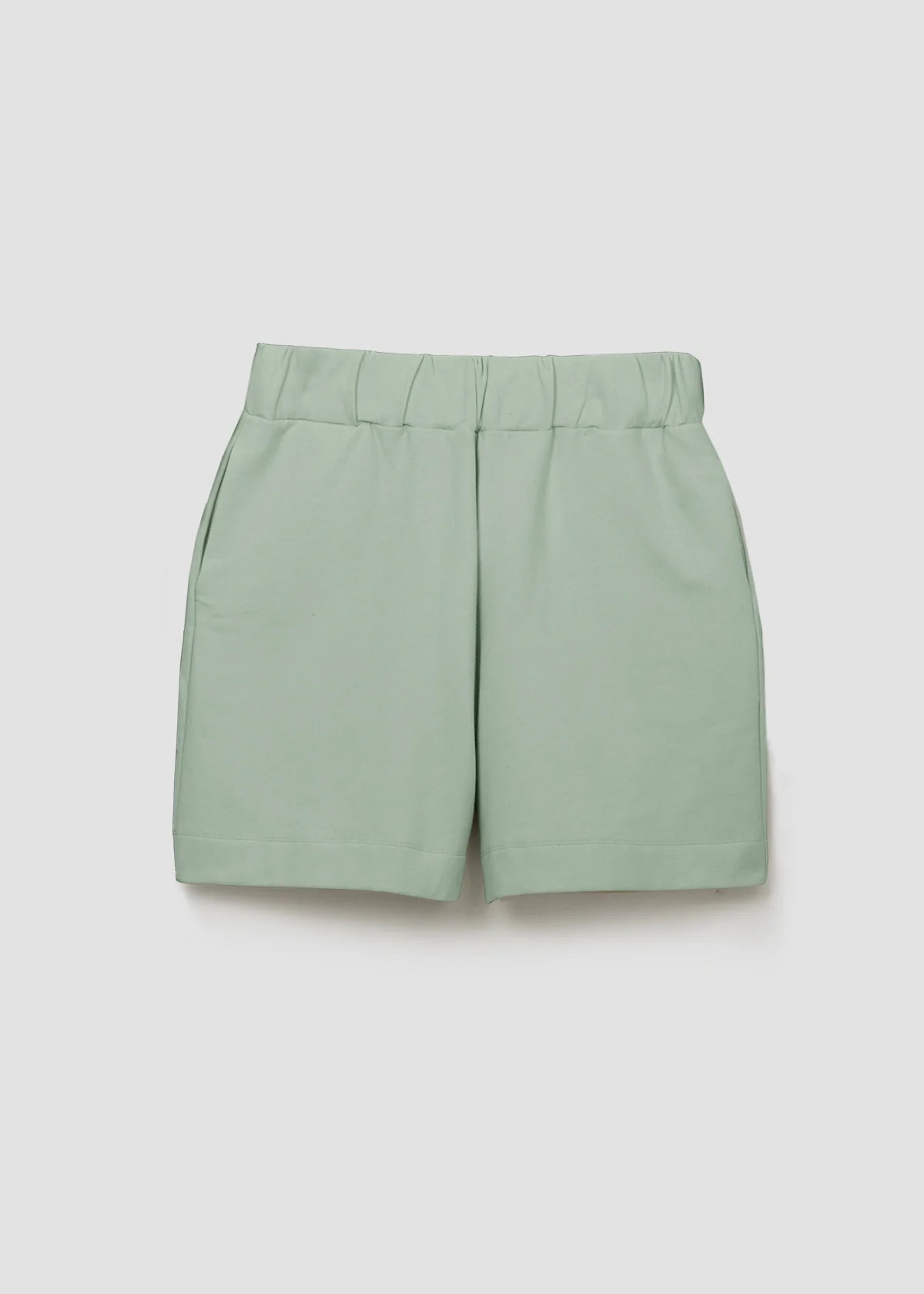 Image of model wearing Beaumont Organic Sylvia Lounge Short in Pistachio Green Felpe Cotton. Sylvia is a relaxed fitting pull-on lounge short that hits mid-knee length. Ethically made in Portugal from organic Cotton.