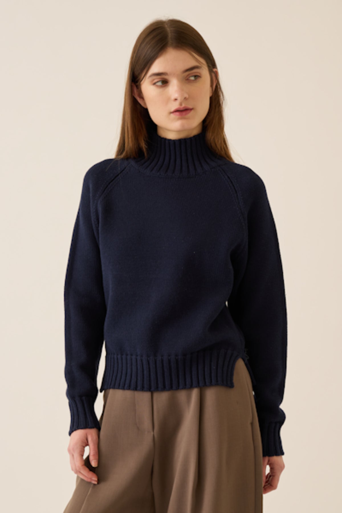 Image of model wearing DEMYLEE Kaitlyn Cotton Cashmere Turtleneck Sweater in Deep Navy.