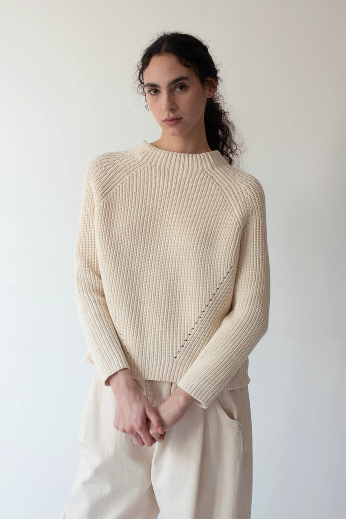 Image of DEMYLEE NEW YORK Daphne Washed Cotton Sweater in Natural White. Daphne has a mocked neck with pointelle seam details.
