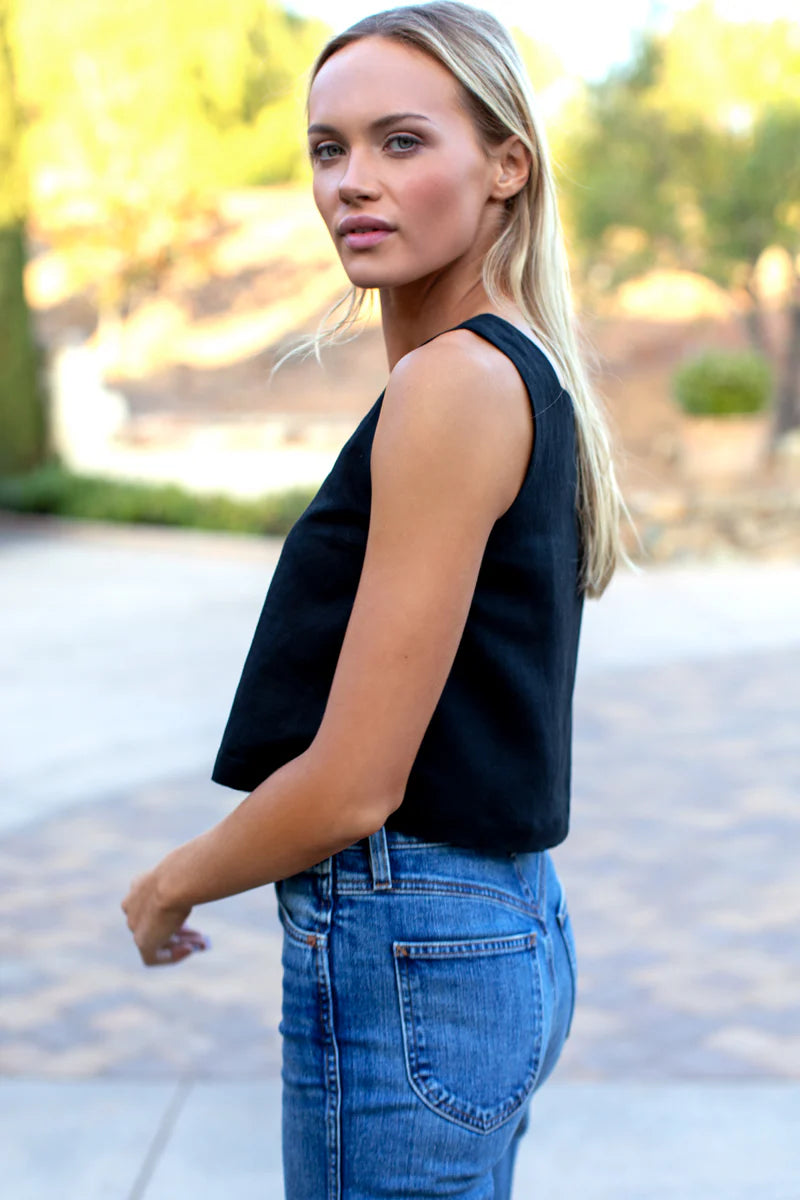 Image of model wearing Emerson Fry Roma 2 Top in Black Linen. Roma Top is a square neck sleeveless shell top with a slightly cropped length. Made in USA.