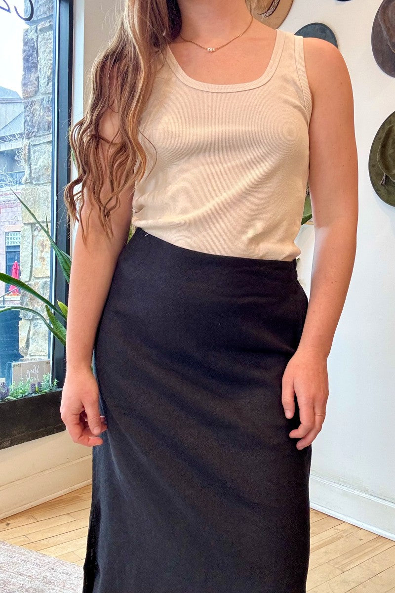 Image of IT IS WELL LA Linen Slit Skirt in Black. This classic, relaxed pencil skirt hits at the ankle with symmetrical side slits. Made in USA.