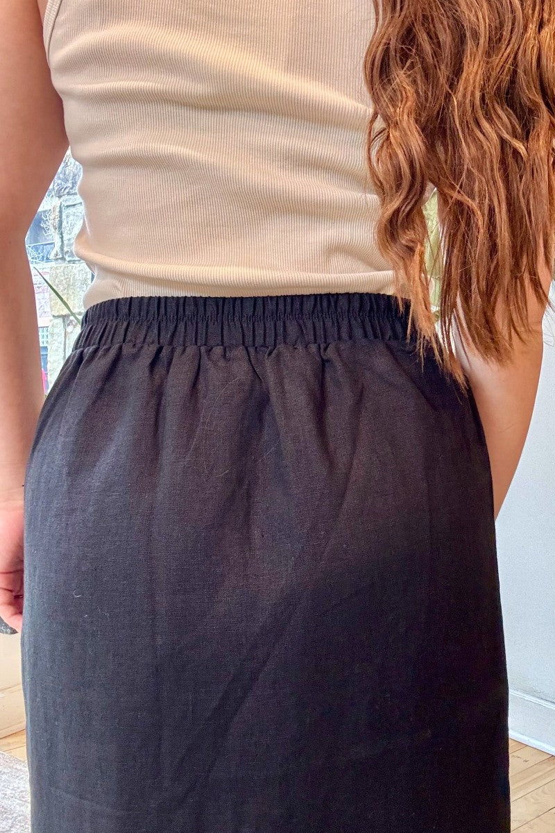 Image of IT IS WELL LA Linen Slit Skirt in Black. This classic, relaxed pencil skirt hits at the ankle with symmetrical side slits. Made in USA.