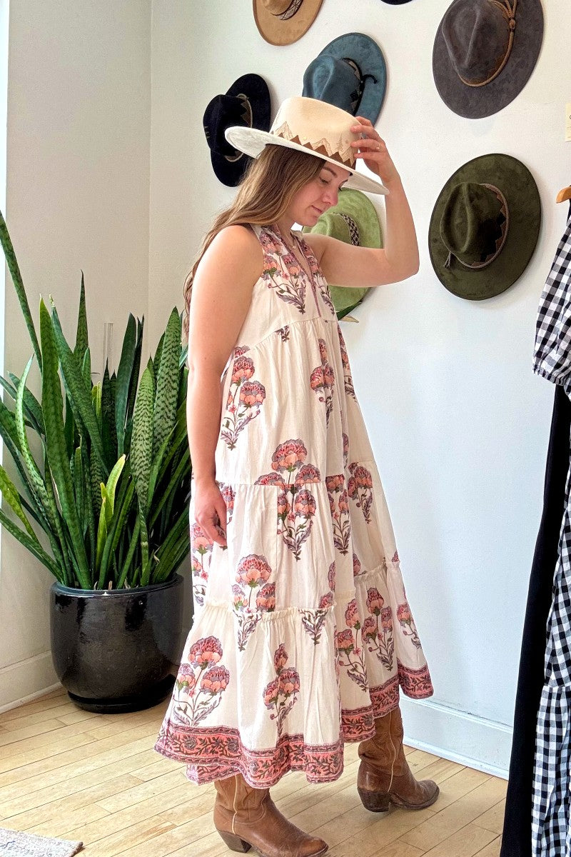 Image of model wearing MAELU DESIGNS Poppy Tiered Sundress. Poppy dress is a halter style sundress with flowing, tiered a line skirt, v-neck opening, and frilled bodice in a hand block printed Mischa Floral Cotton.