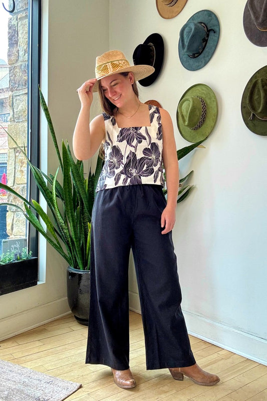 Image of NARY RESORT Koh Rong Lounge Pant in Black Deadstock Linen. These pants have a high rise, frilled drawstring waist, and a full inseam with a wide leg opening. Ethically made in Cambodia.