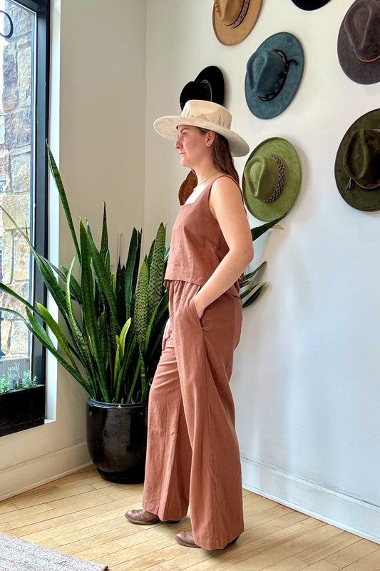 Image of NARY RESORT Koh Rong Lounge Pant in Clay Deadstock Linen. These pants have a high rise, frilled drawstring waist, and a full inseam with a wide leg opening. Ethically made in Cambodia.