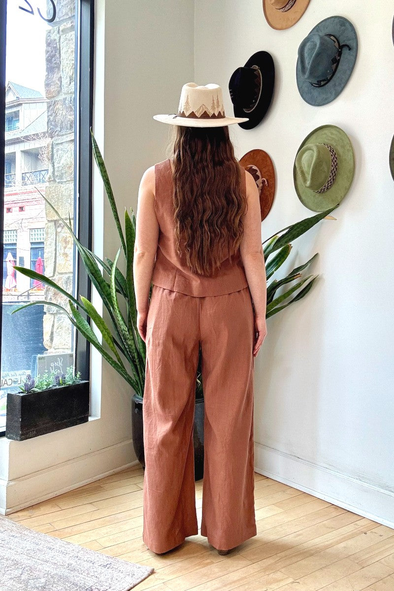 Image of NARY RESORT Koh Rong Lounge Pant in Clay Deadstock Linen. These pants have a high rise, frilled drawstring waist, and a full inseam with a wide leg opening. Ethically made in Cambodia.