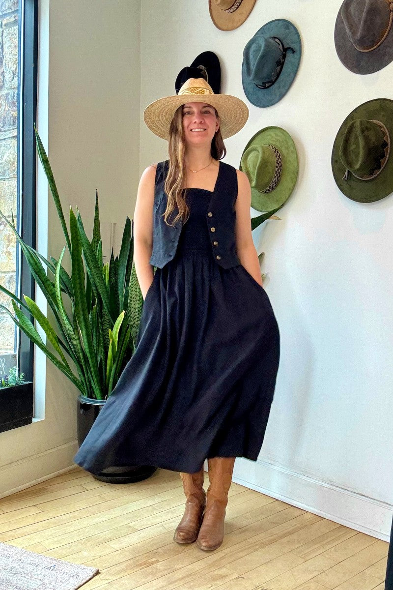 Image of NARY RESORT Shirred Tube Midi Sundress in Black Deadstock linen. This midi length dress has a gathered, pintuck bodice, a-line skirt, and side pockets. Ethically made in Cambodia.