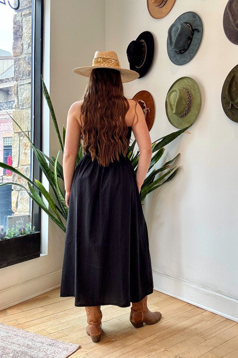 Image of NARY RESORT Shirred Tube Midi Sundress in Black Deadstock linen. This midi length dress has a gathered, pintuck bodice, a-line skirt, and side pockets. Ethically made in Cambodia.