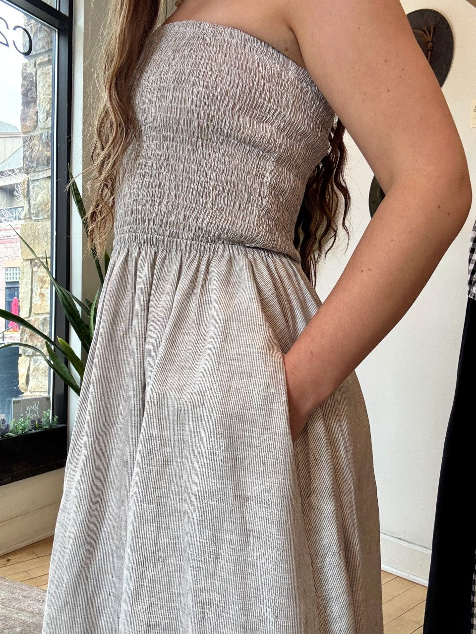 Image of NARY RESORT Shirred Tube Midi Sundress in Grey Stripe Deadstock linen. This midi length dress has a gathered, pintuck bodice, a-line skirt, and side pockets. Ethically made in Cambodia.