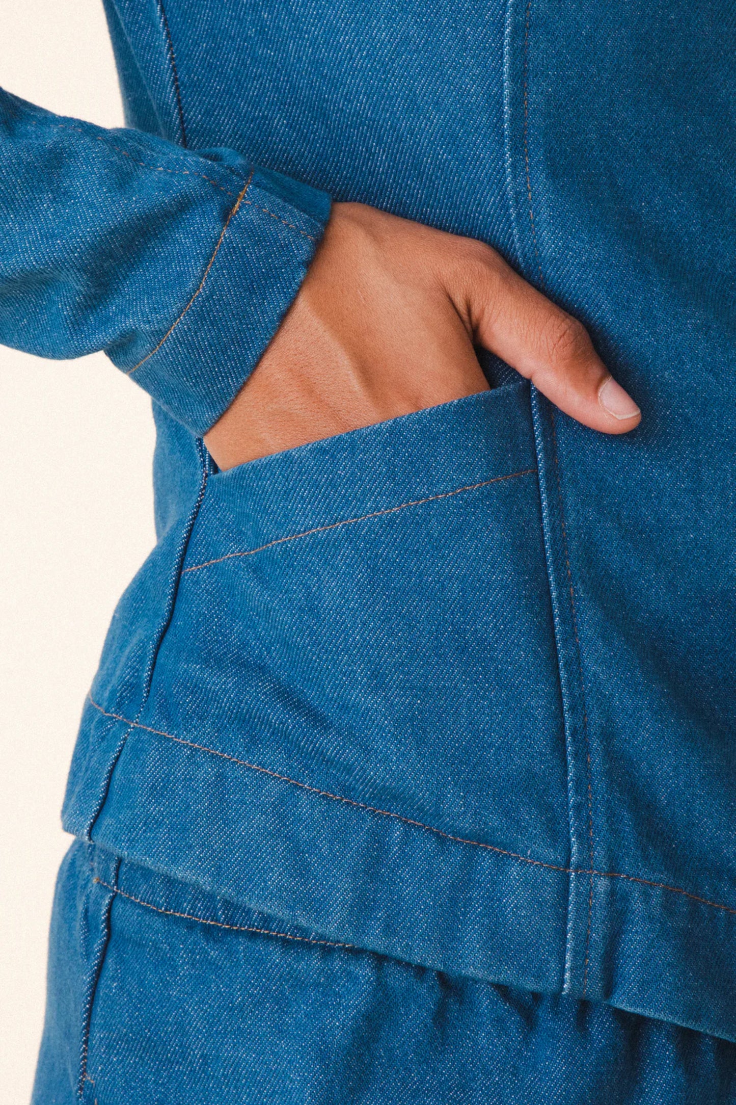 Image of model wearing Prairie Underground Dune Tailored Jean Jacket. Dune Jacket is a tailored collarless jacket with a hidden zip front closure. Designed and produced in Seattle, Washington.