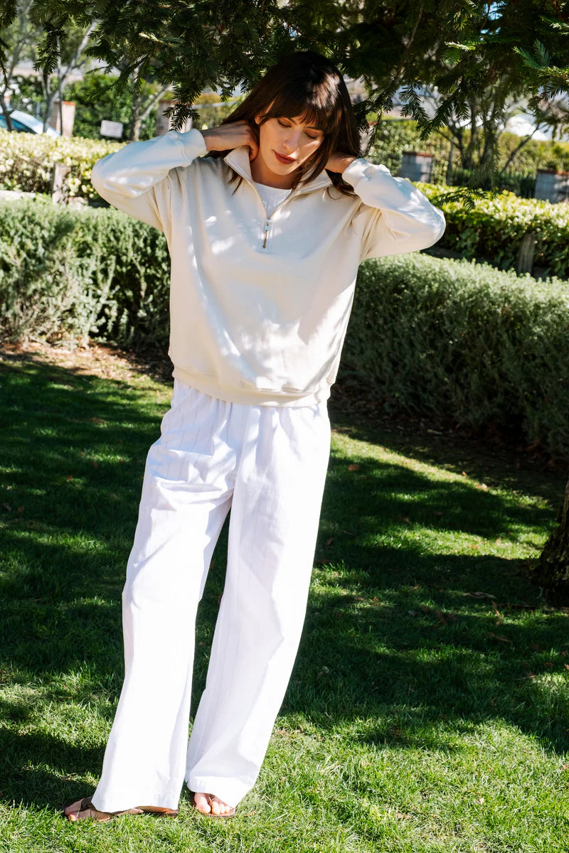 Image of model wearing Whimsy + Row Diana Half Zip Pullover in Cream White. Made in USA from organic cotton fleece.