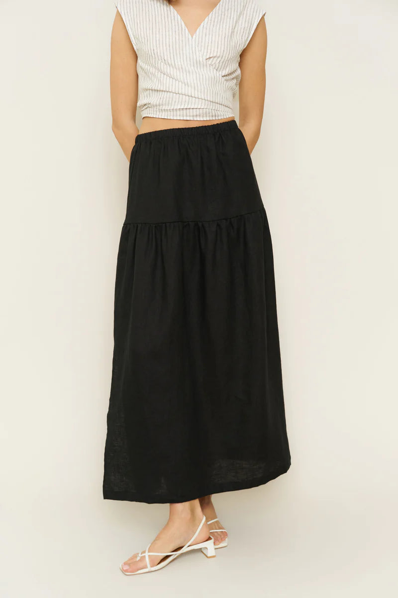 Image of model wearing Millie Convertible Skirt in Black Linen. Millie is a gathered waist Maxi skirt with side slit that can also be worn as a breezy tube dress. Made in USA.