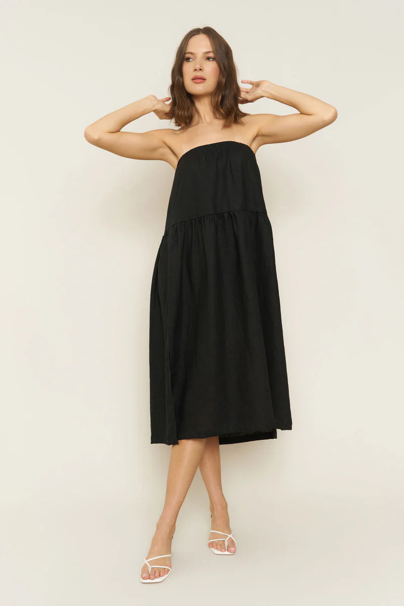 Image of model wearing Millie Convertible Skirt in Black Linen. Millie is a gathered waist Maxi skirt with side slit that can also be worn as a breezy tube dress. Made in USA.