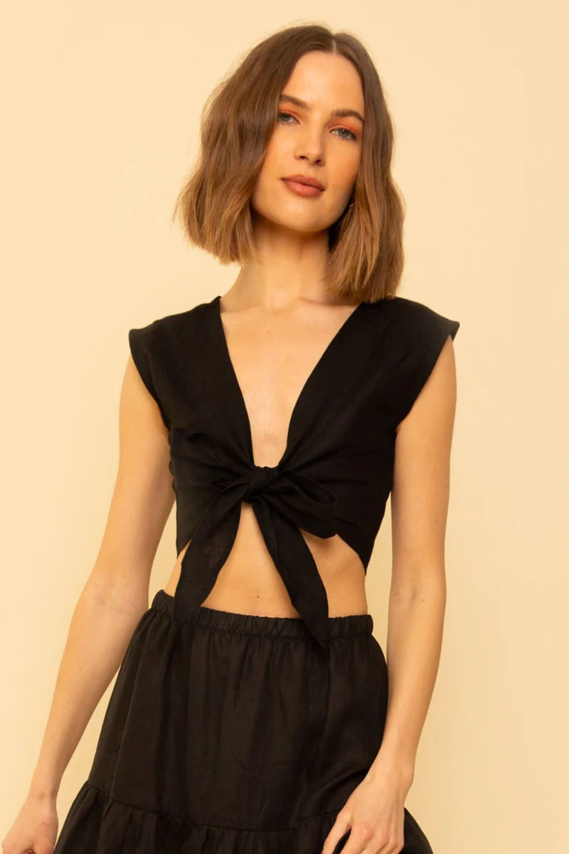 Image of model wearing Whimsy + Row Valentina Tie Top in Black Linen. Valentina Top is a square shoulder crop top with tie closure that can be worn back to front. Made in Los Angeles.
