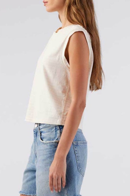 Image of model wearing AMO Denim Babe Sleeveless Cropped Tee in Natural White. Babe Tee is a muscle style sleeveless tee with a crew neck and cropped length. Designed and produced in Los Angeles.