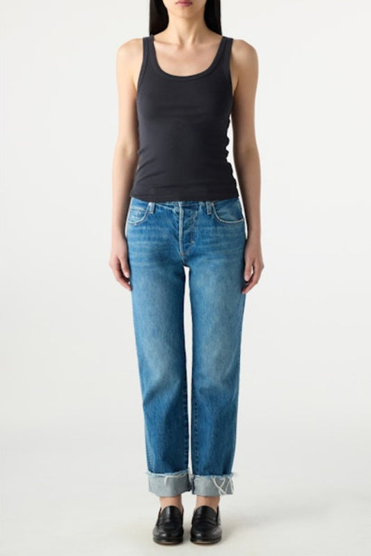 Image of model wearing AMO DENIM Camryn Jean in Magnetic. Cameron is a mid-rise 100% Cotton mid-wash denim with a tapered, straight leg opening. Designed to wear with cuffed hem.