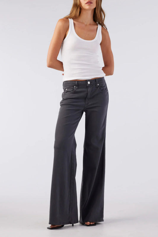 Image of model wearing AMO Denim Elizabeth Flare Jean in Pewter Black. Elizabeth Flare is a Premium Mid-Rise Denim with a Bell Bottom Flare Leg Opening. Made in Los Angeles from Eco-Friendly Cotton-Lyocell Denim.