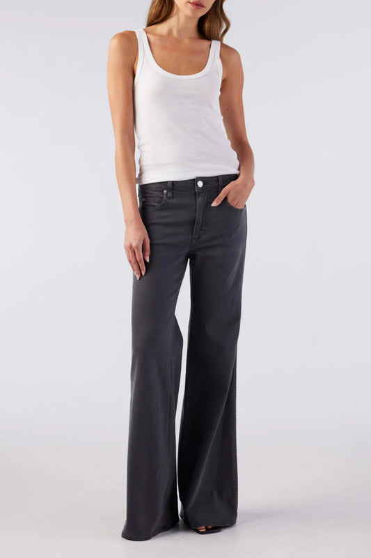 Image of model wearing AMO Denim Elizabeth Flare Jean in Pewter Black. Elizabeth Flare is a Premium Mid-Rise Denim with a Bell Bottom Flare Leg Opening. Made in Los Angeles from Eco-Friendly Cotton-Lyocell Denim.