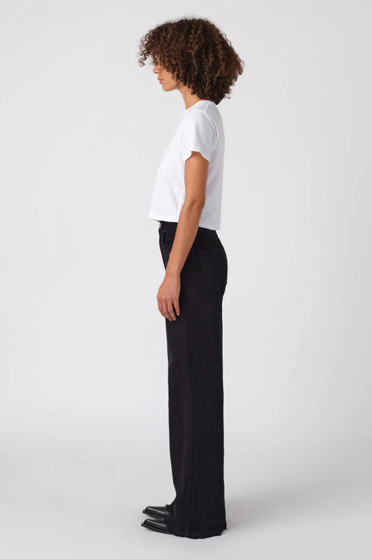 Image of model wearing AMO DENIM Friday Wide Leg in Black Oak. Frida is a high rise, wide leg sailor cut jean in a true black wash.