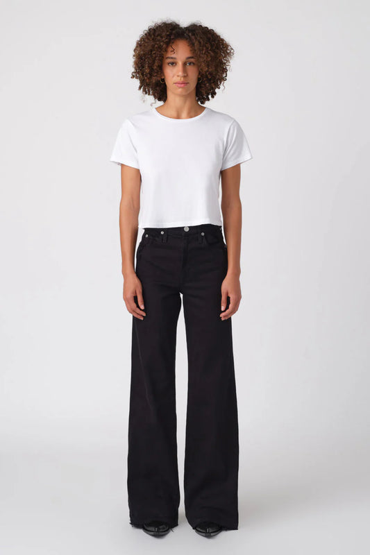 Image of model wearing AMO DENIM Friday Wide Leg in Black Oak. Frida is a high rise, wide leg sailor cut jean in a true black wash.