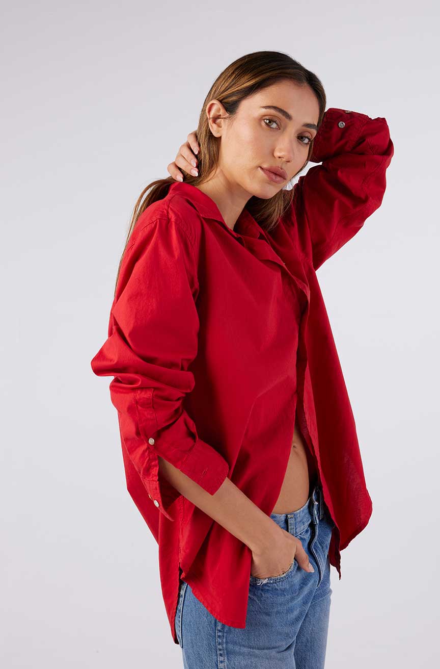 Image of model wearing AMO Denim Ruth Oversized Button Down Shirt in Cherry Red Cotton Poplin. Made in Peru premium women's denim and basics. Female founded and operated.