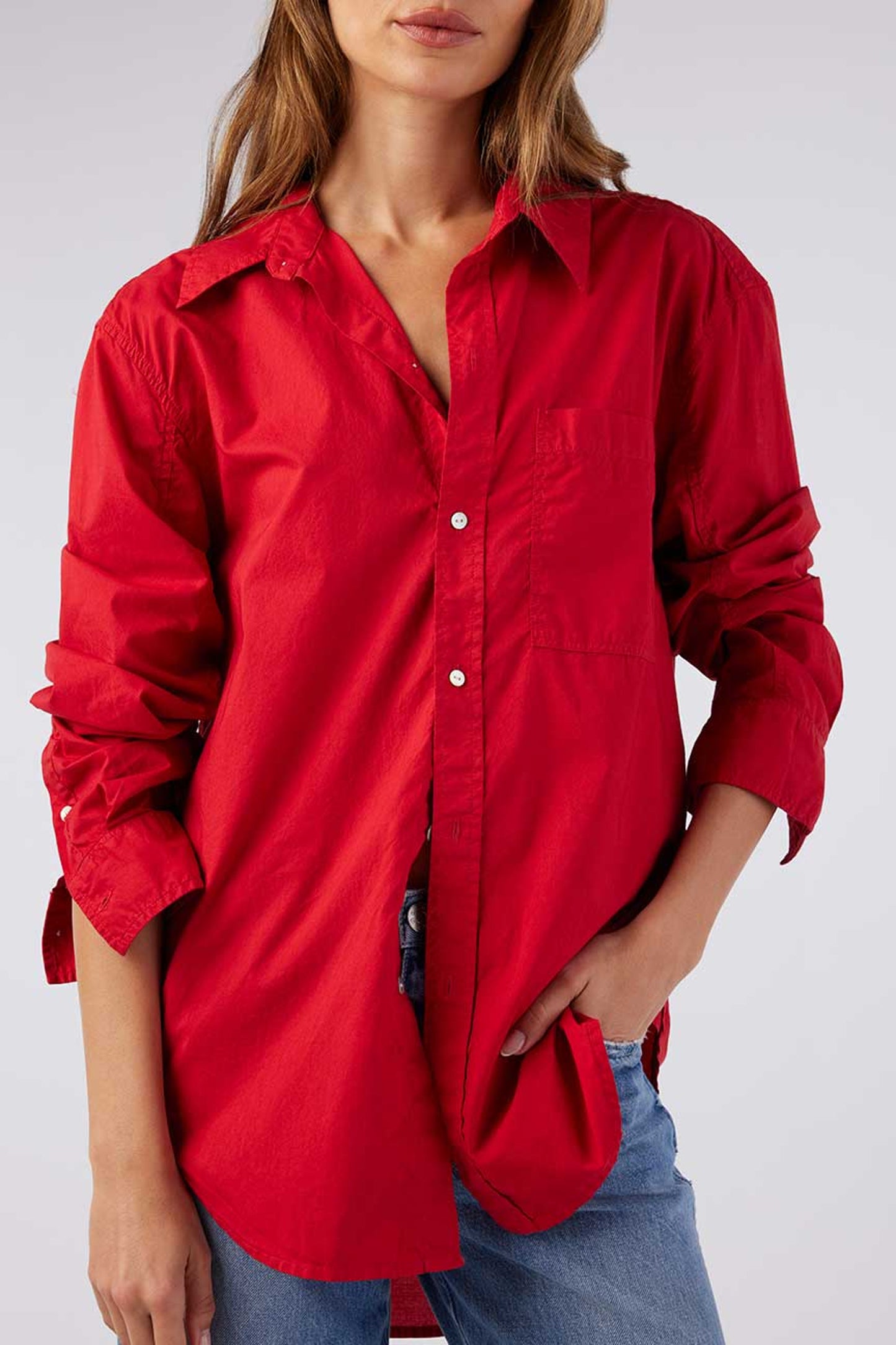 Image of model wearing AMO Denim Ruth Oversized Button Down Shirt in Cherry Red Cotton Poplin. Made in Peru premium women's denim and basics. Female founded and operated.