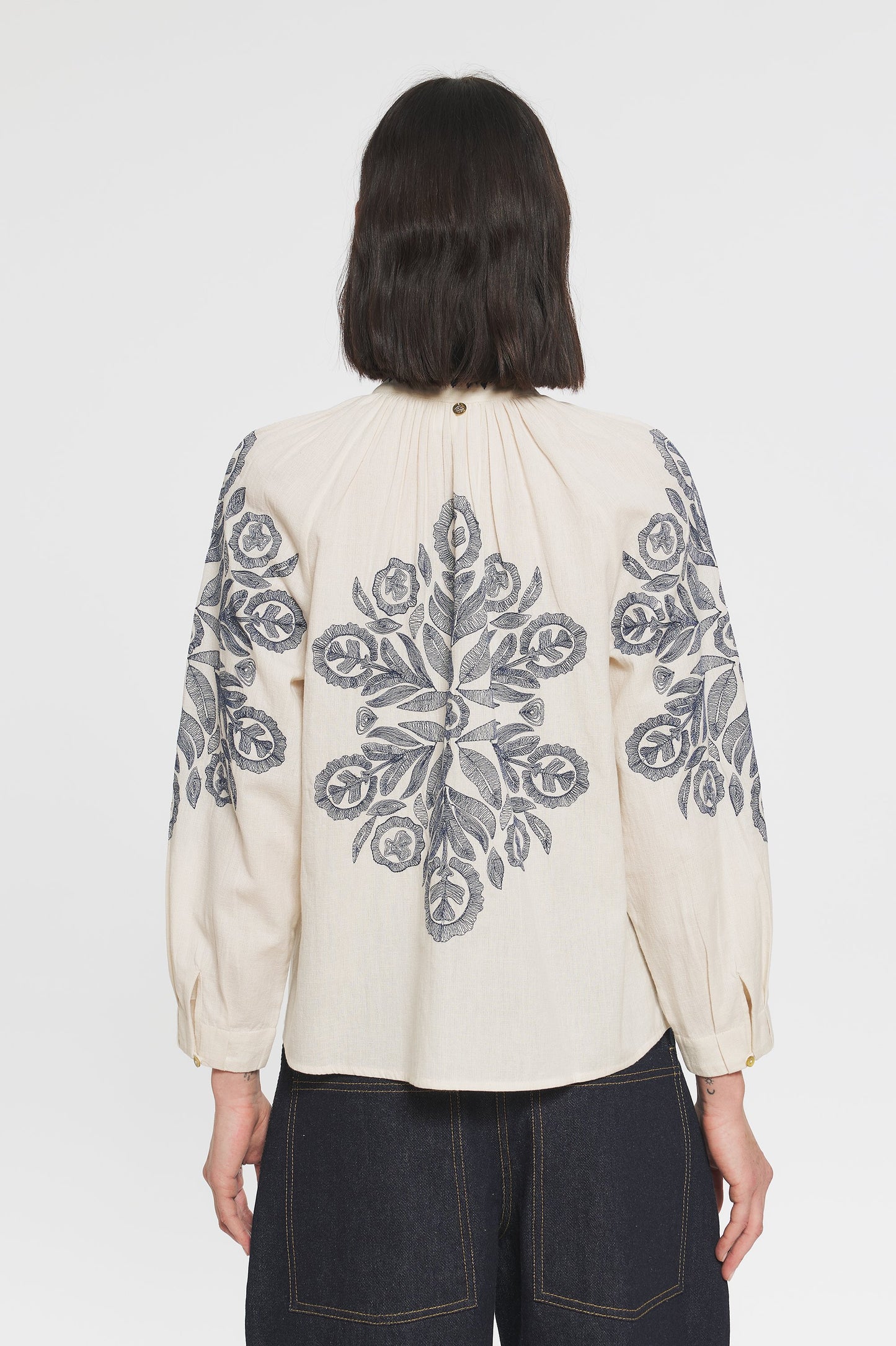 Image of model in Antik Batik Eglantine Hungarian Inspired Hand Embroidered Cotton Blouse _ Cream Peasant Popover Blouse with Hand Stitched Abstract Floral Embroidery _ Ethical French Bohemian Fashion _ Artisan Made Sustainable High Fashion