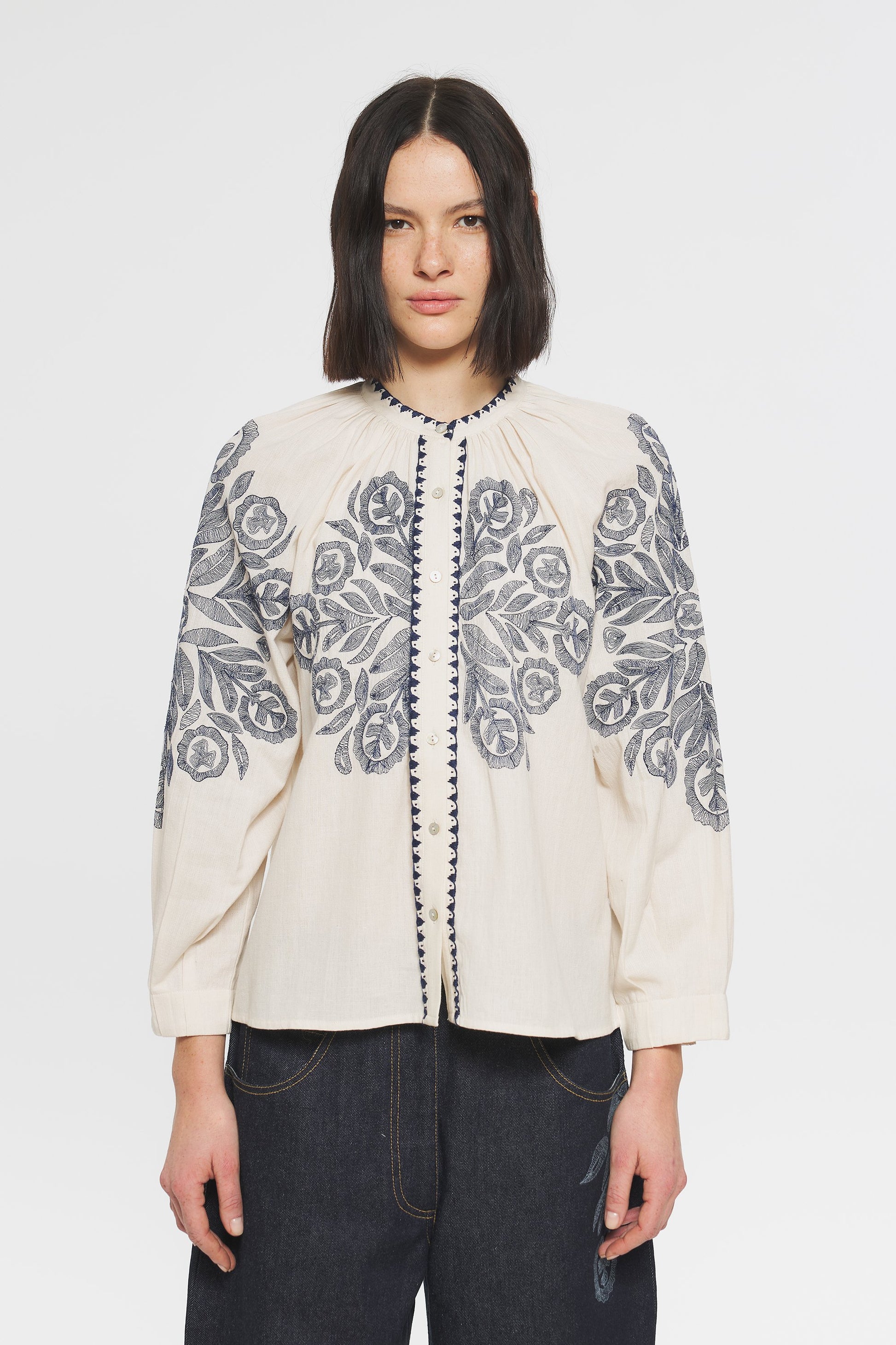 Image of model in Antik Batik Eglantine Hungarian Inspired Hand Embroidered Cotton Blouse _ Cream Peasant Popover Blouse with Hand Stitched Abstract Floral Embroidery _ Ethical French Bohemian Fashion _ Artisan Made Sustainable High Fashion