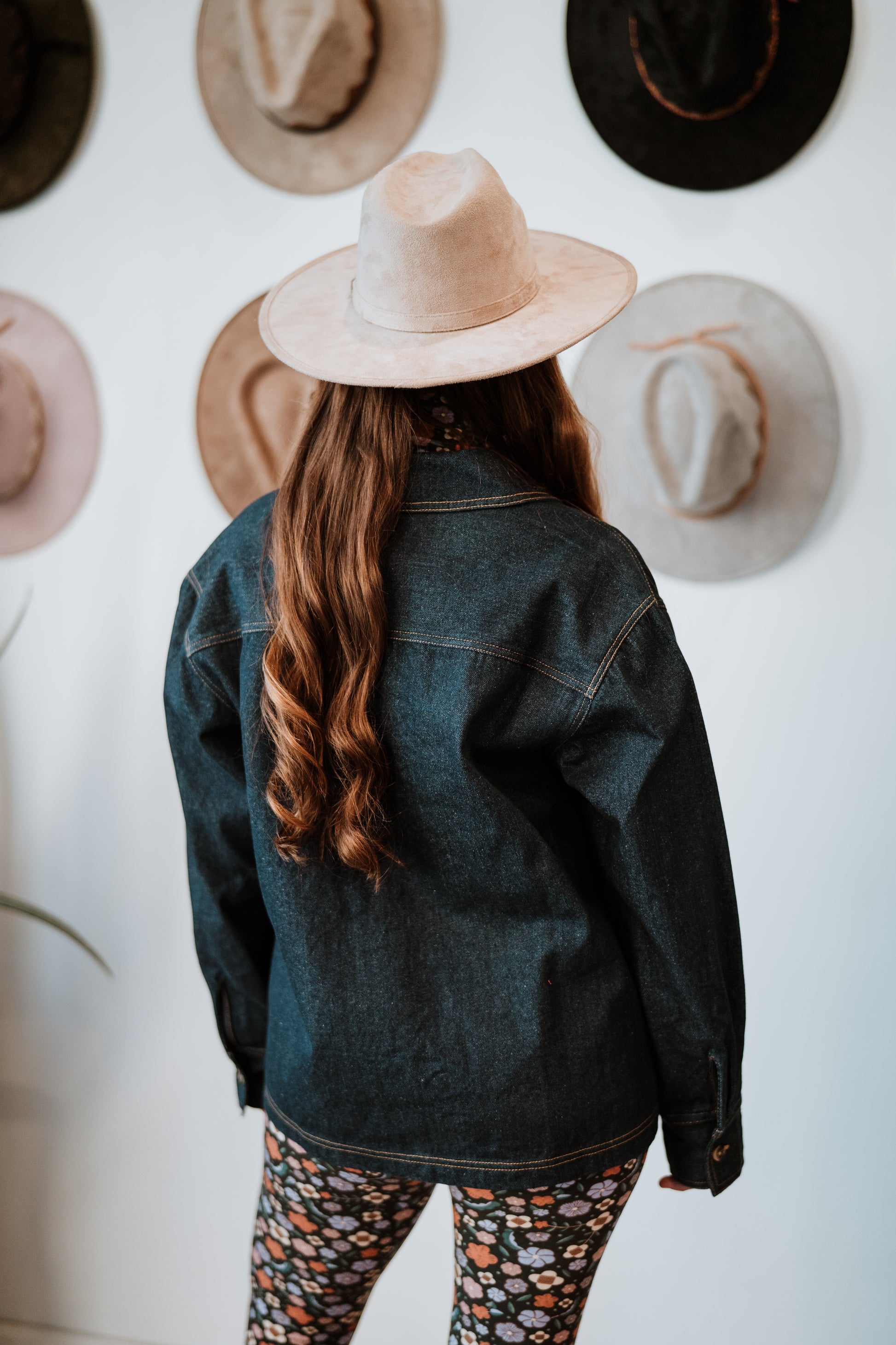 Image of model in Antik Batik Eglantine Indigo Dyed Denim Chore Jacket with Hand Stitched Tonal Floral Embroidery _ Ethical French Bohemian Fashion _ Artisan Made Sustainable High Fashion