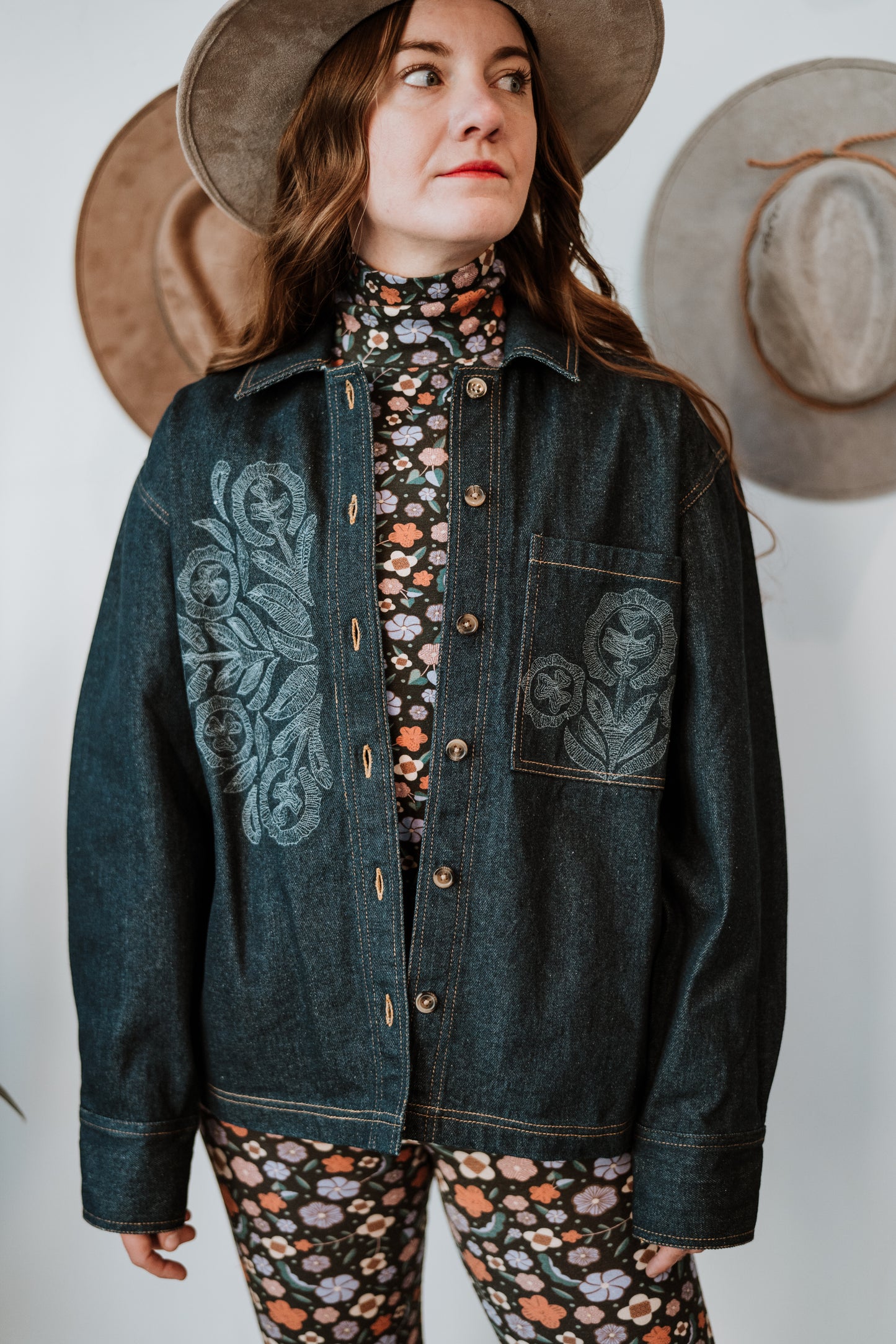 Image of model in Antik Batik Eglantine Indigo Dyed Denim Chore Jacket with Hand Stitched Tonal Floral Embroidery _ Ethical French Bohemian Fashion _ Artisan Made Sustainable High Fashion