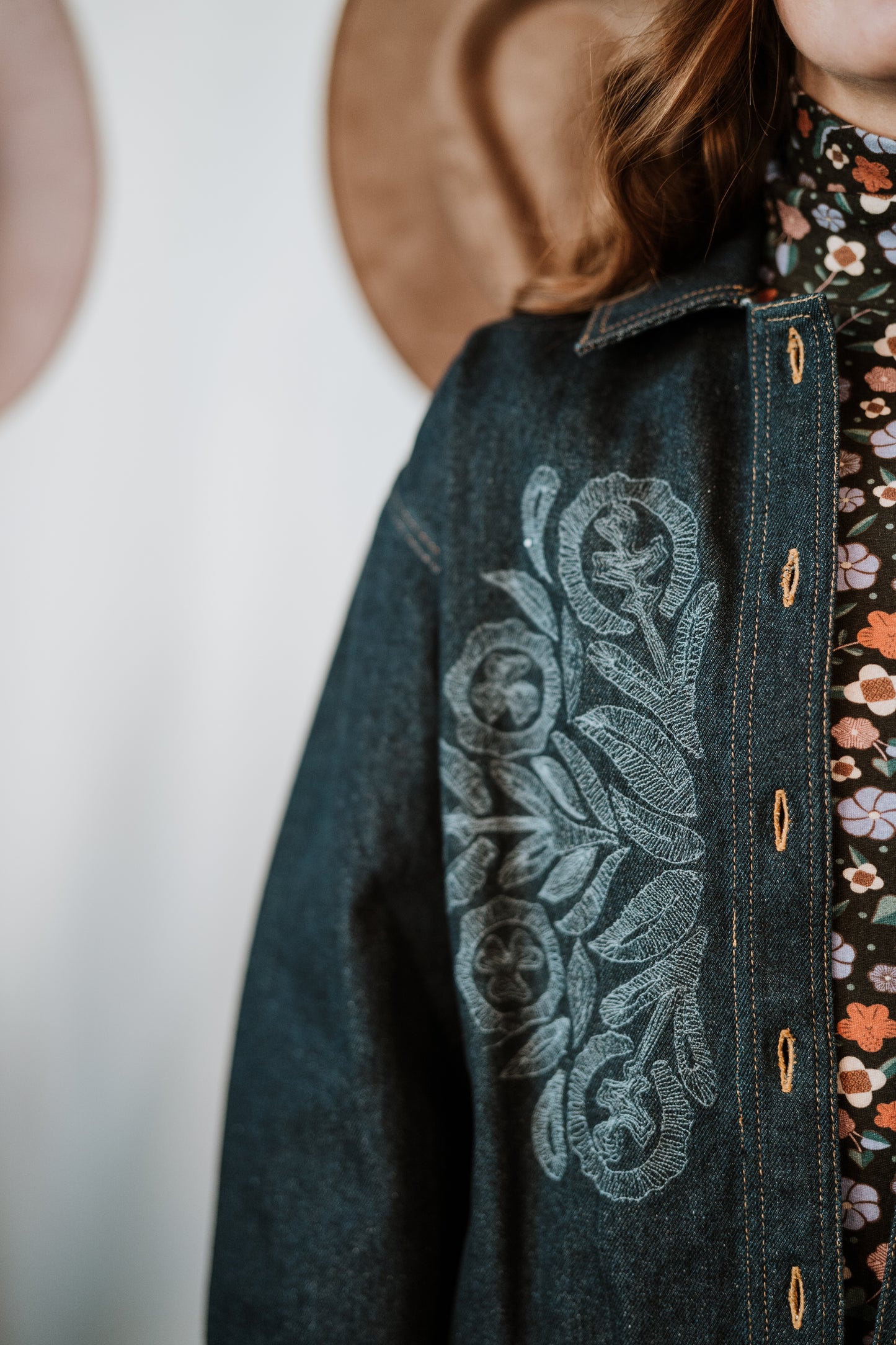 Close up of Hand Embroidery details on Antik Batik Eglantine Indigo Dyed Denim Chore Jacket with Hand Stitched Tonal Floral Embroidery _ Ethical French Bohemian Fashion _ Artisan Made Sustainable High Fashion