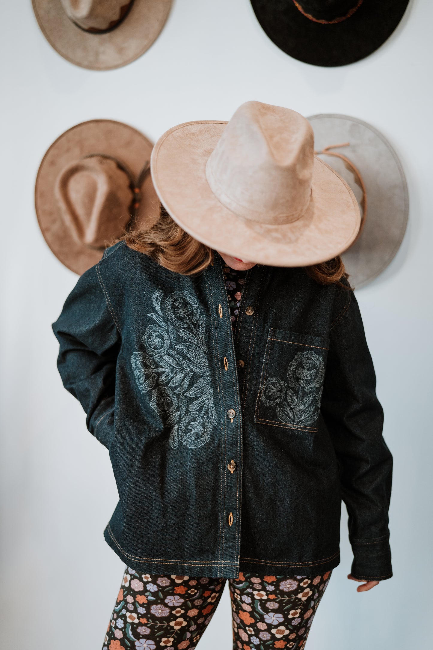 Image of model in Antik Batik Eglantine Indigo Dyed Denim Chore Jacket with Hand Stitched Tonal Floral Embroidery _ Ethical French Bohemian Fashion _ Artisan Made Sustainable High Fashion