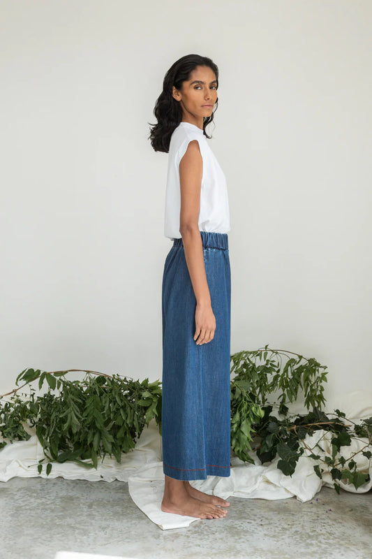 Image of model wearing Beaumont Organic Evora Leigh Wide Leg Trouser. Evora Leigh is a draped, pull-on, wide leg trouser with slightly cropped length. Ethically made in Portugal from organic cotton denim.