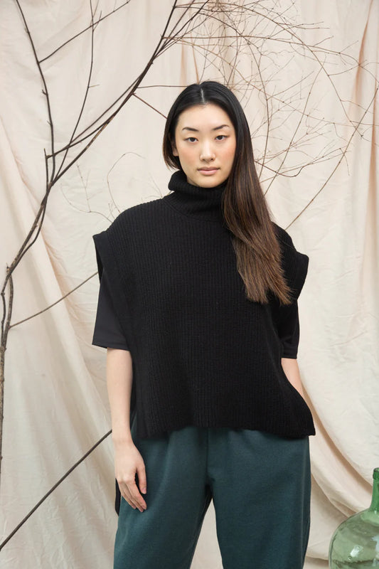 Image of model wearing BEAUMONT ORGANIC Kanon Reyclced Wool Knit Vest in Black.