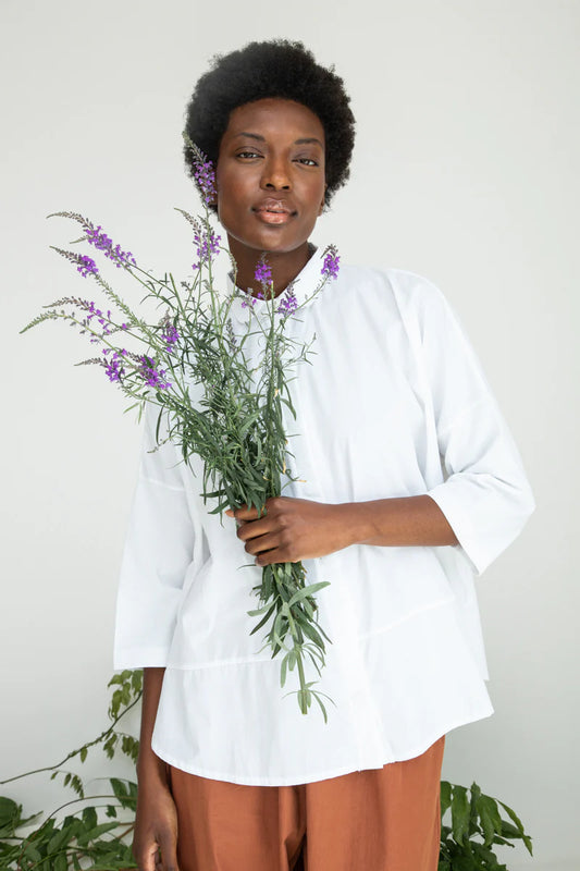 Image of model wearing BEAUMONT ORGANIC Lissie Button Down in White. Lissie is a 3/4 sleeve length boxy button down made from organic Cotton poplin and cotton jersey.