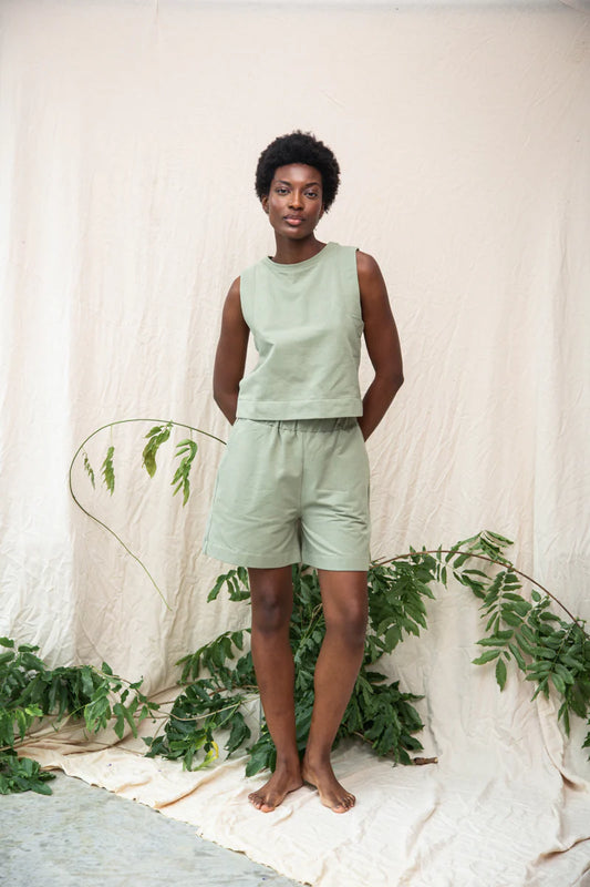 Image of model wearing Beaumont Organic Sylvia Lounge Short in Pistachio Green Felpe Cotton. Sylvia is a relaxed fitting pull-on lounge short that hits mid-knee length. Ethically made in Portugal from organic Cotton.