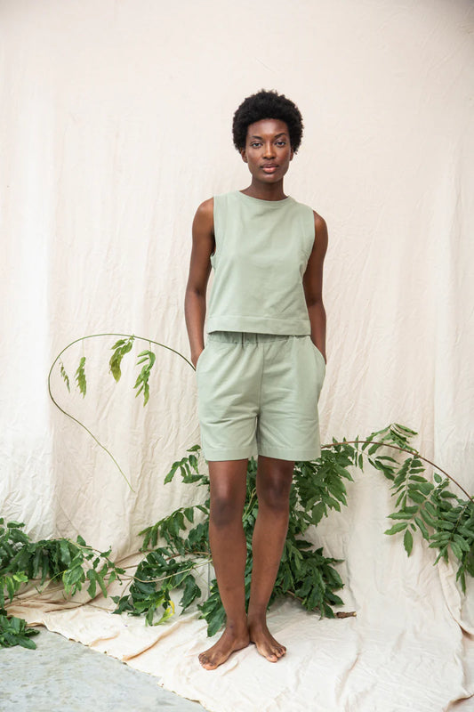 Image of model wearing Beaumont Organic Sylvia Lounge Short in Pistachio Green Felpe Cotton. Sylvia is a relaxed fitting pull-on lounge short that hits mid-knee length. Ethically made in Portugal from organic Cotton.