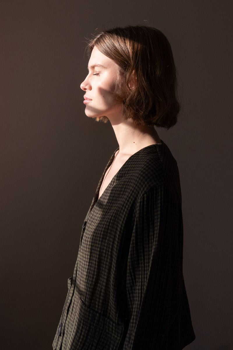 Image of model wearing BIBICO Fair Trade Clothing Irma Overshirt in Olive Checkered Gauze Cotton. 