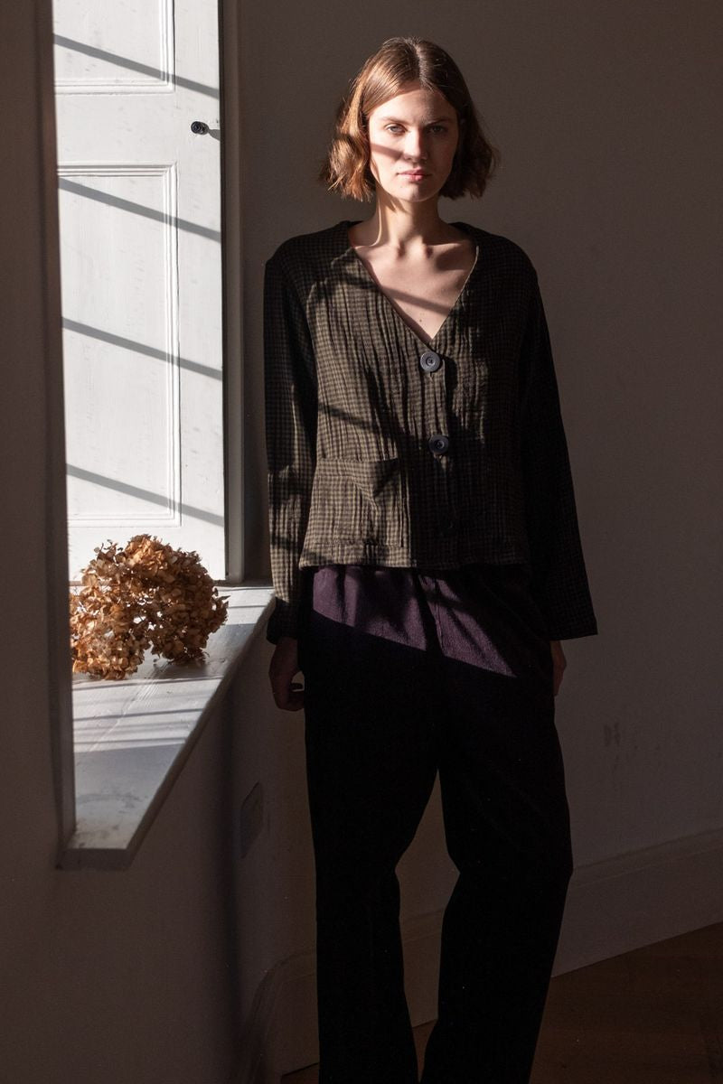 Image of model wearing BIBICO Fair Trade Clothing Irma Overshirt in Olive Checkered Gauze Cotton. 
