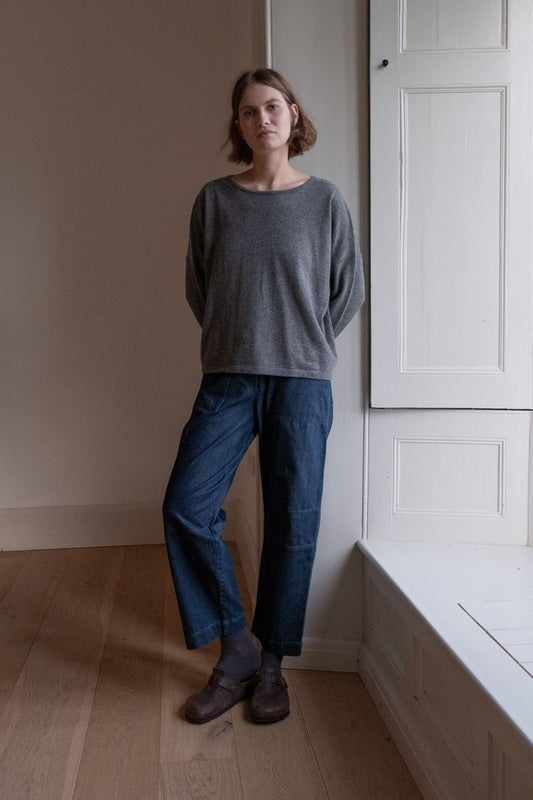 Image of model wearing BIBICO Fair Trade Clothing Margate Relaxed Barrel Leg Trouser in Heavy Indigo Denim. 